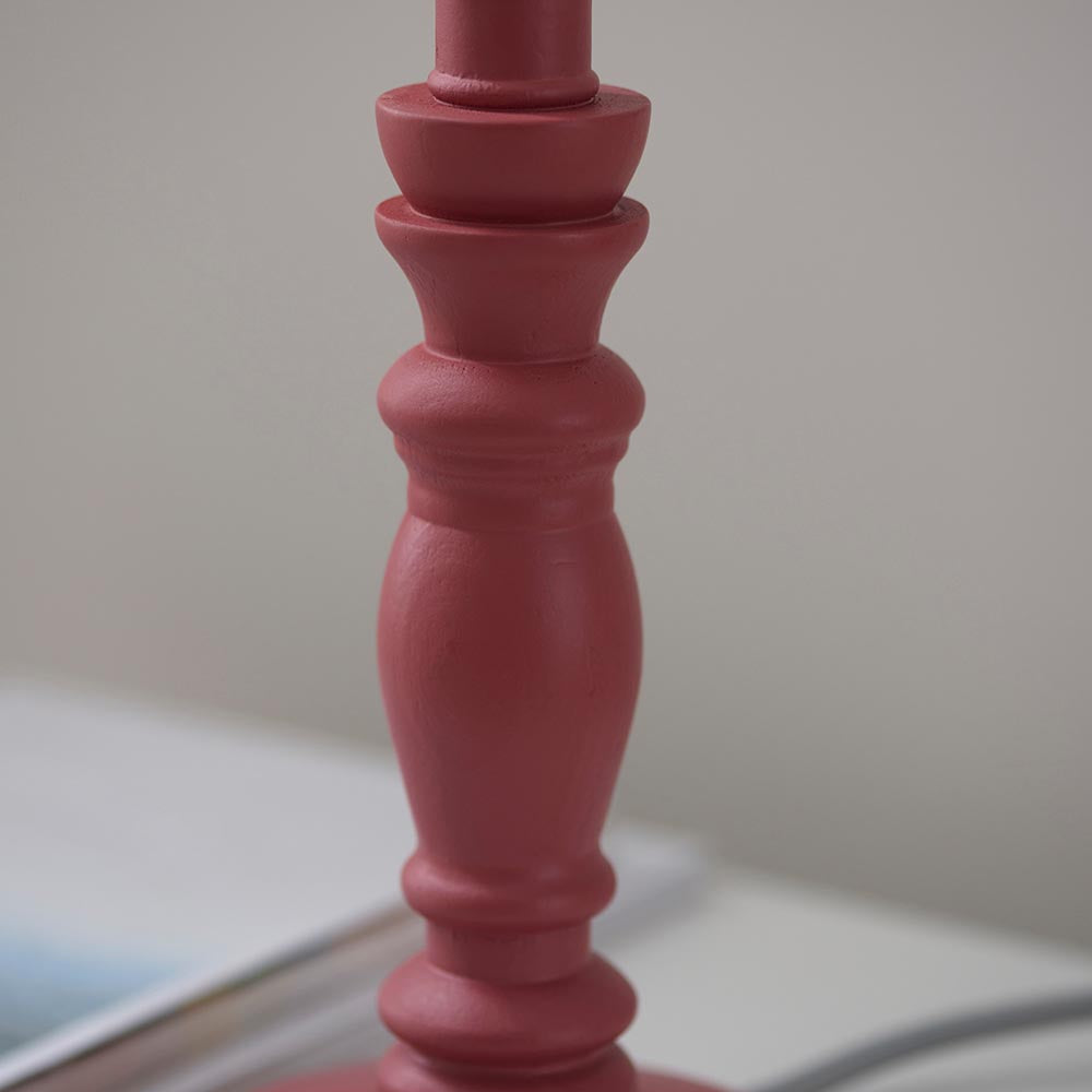 Close-up of the Endon Aldworth table lamp's turned wood spindle in soft pink clay satin finish, shown on a light surface.