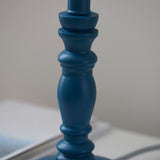 Close-up of the Endon Aldworth table lamp showing its turned wooden spindle base in satin marlin blue against a neutral background.