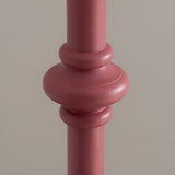 Close-up of the Endon Bevbury floor lamp's turned wooden spindle detail in satin pink clay finish against a neutral background.