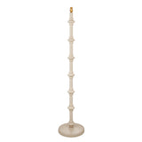 Endon Bevbury floor lamp with a turned wooden spindle base in almond white, brass B22 lamp holder and round base, shown on a plain white background.