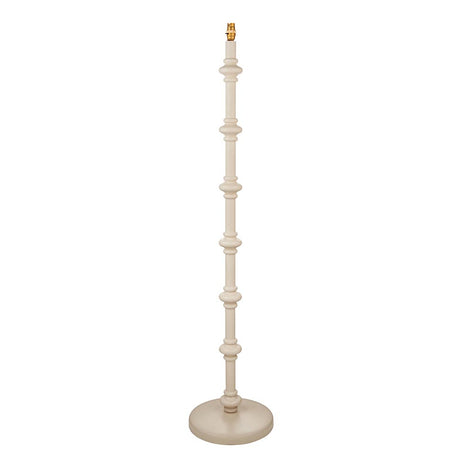 Endon Bevbury floor lamp with a turned wooden spindle base in almond white, brass B22 lamp holder and round base, shown on a plain white background.