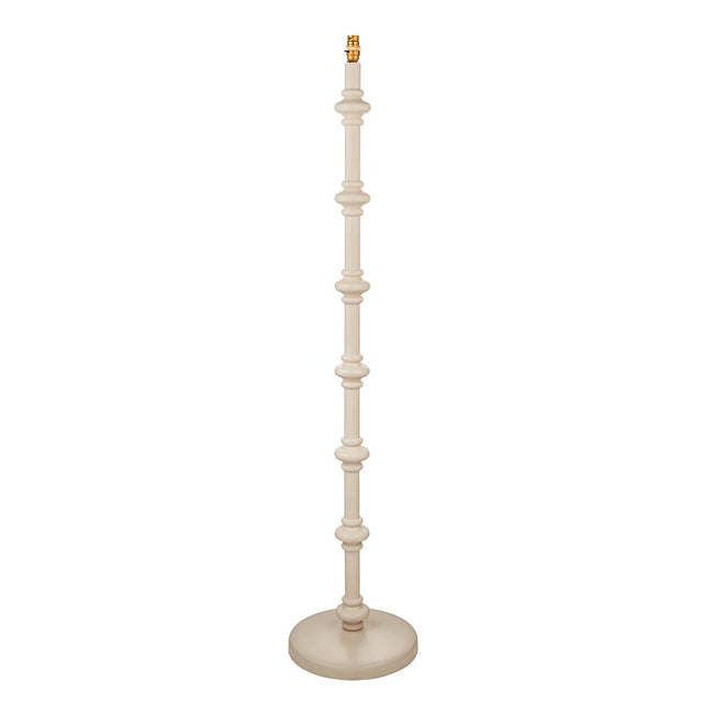 Endon Bevbury floor lamp with a turned wooden spindle base in almond white, brass B22 lamp holder and round base, shown on a plain white background.