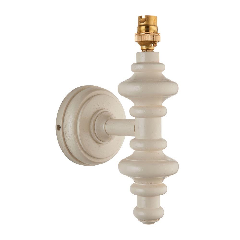 Endon Bevbury wall light with a turned wooden spindle in satin white, brass B22 lamp holder and round wall plate, shown on a plain white background.