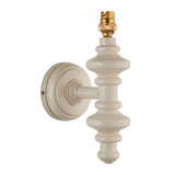 Endon Bevbury wall light with a turned wooden spindle in satin white, brass B22 lamp holder and round wall plate, shown on a plain white background.