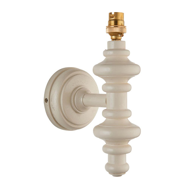 Endon Bevbury wall light with a turned wooden spindle in satin white, brass B22 lamp holder and round wall plate, shown on a plain white background.