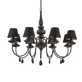 The Wisp 8 Light Chandelier - Black serves as a decorative centerpiece with a black satin enamel finish. Its eight elegantly curved arms, each adorned with a lampshade and teardrop-shaped accents, create a timeless design that hangs beautifully from a chain.