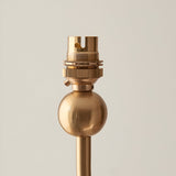Close-up of the Endon Cliffleigh chandelier's brushed aged brass B22 lamp holder and spherical detail on the central stem, against a light background.