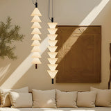 Boga Vertical Up LED Cone Glass Linear Pendant Light in matt black, shown as two stacked columns of upward-facing opal glass cones hanging in a living room above a cream sofa.