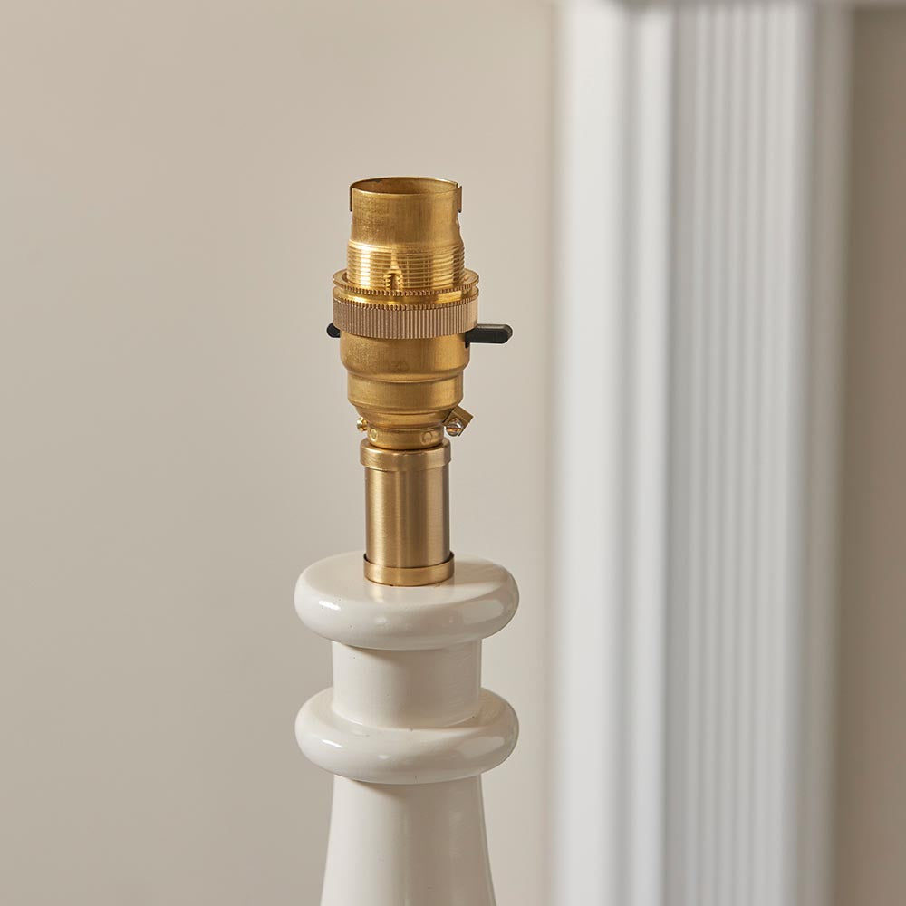 Carlworth Table Lamp base in white resin with a turned spindle shape, topped by a brass B22 bayonet lamp holder and switch.