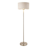 Endon Brenley floor lamp in chrome with a slim metal stem, round base, and natural linen drum shade with metallic inner, on a white background.