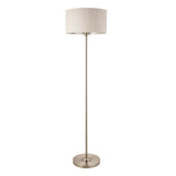 Endon Brenley floor lamp with slim chrome stem, round base, and natural linen drum shade with metallic inner, shown on a plain white background.