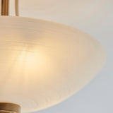 Close-up of the Carlton 3 Light Flush Ceiling Light with a textured white glass shade and brushed aged brass fitting, on a plain light background.