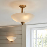 Endon Carlton semi-flush ceiling light and matching wall light in brushed aged brass with matt white glass shades, installed near a window.