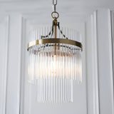 Endon Beaumont two-tier pendant light with clear glass rods and antique brass frame, suspended from a chain in a bright interior setting.