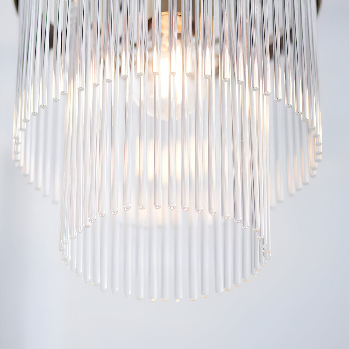 Close-up of Endon Beaumont pendant showing tiered clear glass rods diffusing light from a single E27 lamp within an antique brass fitting.