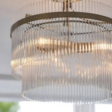 Close-up of Endon Beaumont 3 Light Semi-Flush Ceiling Light in brass, showing tiered glass rod fringes around a circular brass frame with lit lamps.