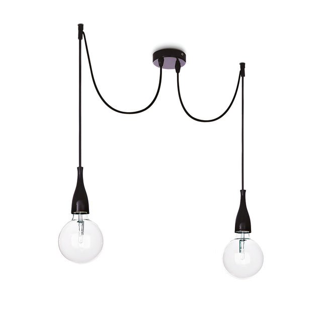 The Auburn 2 Light Pendant - Black is a modern industrial light fixture featuring two exposed bulbs, each hanging from adjustable cords. Its matte black finish elevates the design with a gracefully curved ceiling mount and sleek black bulb holders.