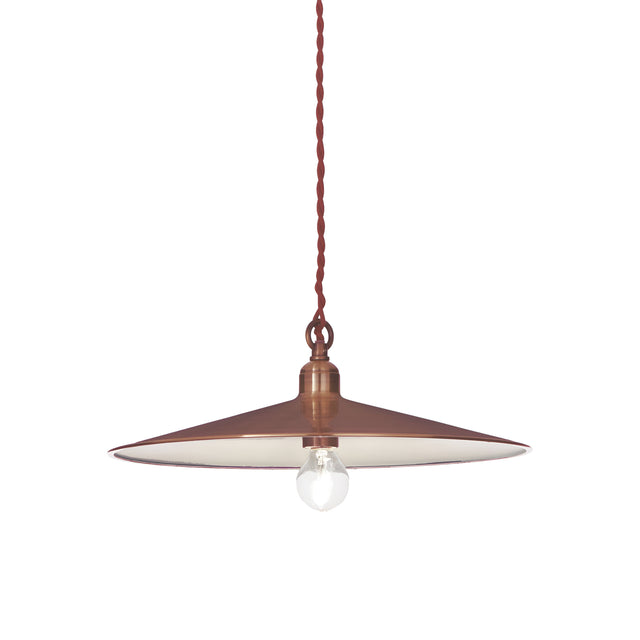 The Sienna 1 Light Pendant - Copper showcases an industrial design with a wide, flat circular shade and an exposed bulb, suspended from a twisted red cord. It offers an adjustable hanging height, ensuring versatile placement.