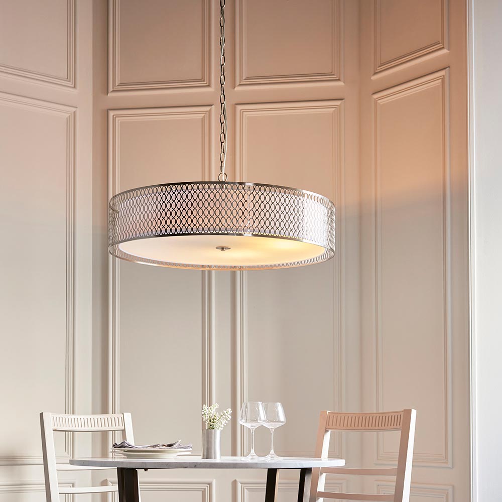 Rosaline 5 Light Pendant in nickel and white, drum shade with fretwork outer and frosted glass diffuser, hung above a dining table in a panelled room.