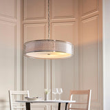 Rosaline 5 Light Pendant in nickel and white, drum shade with fretwork outer and frosted glass diffuser, hung above a dining table in a panelled room.