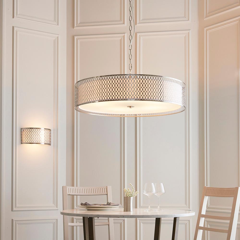 Rosaline 5 Light Pendant in nickel and white, a large drum shade with geometric fretwork outer and frosted glass diffuser, hung above a dining table.