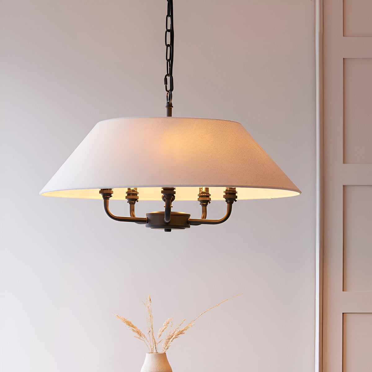 Endon Caldmere 5 light pendant with a wide tapered natural linen shade and matt black metalwork on a chain suspension, shown in a neutral interior.