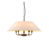 Endon Caldmere 5 light pendant with a wide tapered natural linen shade on antique brass arms, suspended from a black chain against a white background.