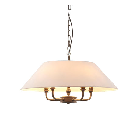 Endon Caldmere 5 light pendant with a wide tapered natural linen shade on antique brass arms, suspended from a black chain against a white background.
