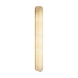 Bastian LED Alabaster Linear Wall Light, a slim vertical bar with rounded ends and cloudy stone markings, glowing warm white against a plain background.