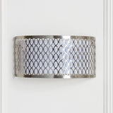 Endon Rosaline 2 light wall light in satin nickel with geometric fretwork outer and white fabric inner shade, mounted on a pale panelled wall.