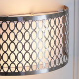 Close-up of Endon Rosaline 2 light wall light in satin nickel with circular geometric fretwork, white fabric inner shade, and curved form against a pale wall.