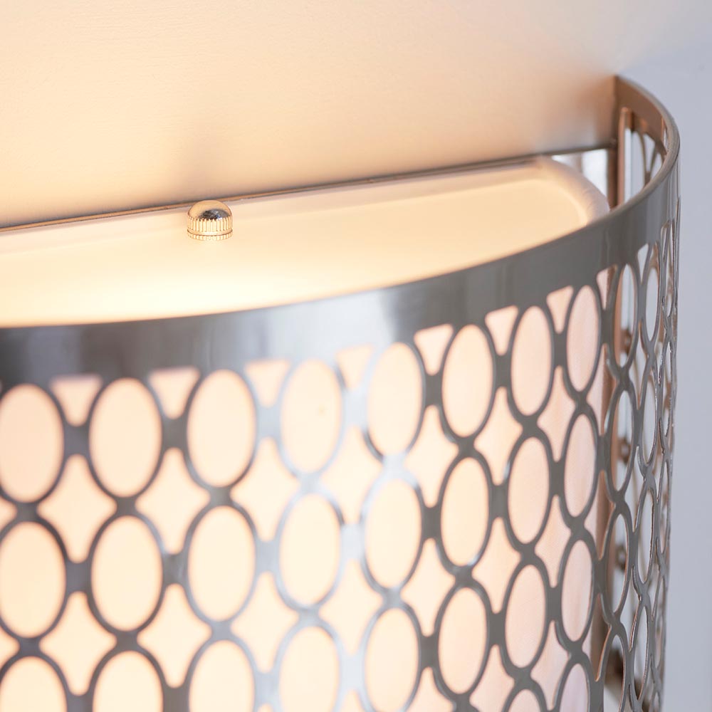 Close-up of Endon Rosaline 2 light wall light showing satin nickel geometric fretwork, white fabric inner shade, and frosted glass top diffuser.