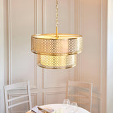 Endon Rosaline 6 Light Chandelier in gold with two tiers of decorative fretwork and white inner shade, suspended above a dining table.