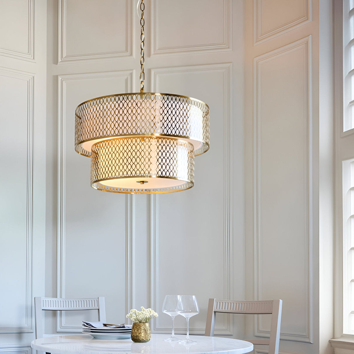 Endon Rosaline 6 light chandelier in gold with two tiered fretwork rings and white inner shade, hanging above a dining table in a panelled room.