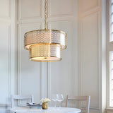 Endon Rosaline 6 light chandelier in gold with two tiered fretwork rings and white inner shade, hanging above a dining table in a panelled room.