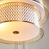 Close-up of Endon Rosaline 6 Light Chandelier in gold, showing tiered circular fretwork bands, white fabric inner shade and frosted glass diffuser.