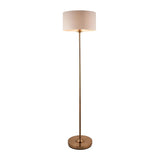 Brenley Floor Lamp in brass with slim tall stem, round base, and drum-shaped fabric shade, shown on a plain white background.