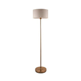 Brenley floor lamp in brass finish with a round base, slim stem, and drum-shaped fabric shade, shown on a plain white background.
