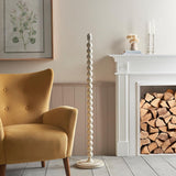 Endon Brenleigh floor lamp base in white with stacked glossy metal spheres, shown beside a mustard armchair and white fireplace in a living room.