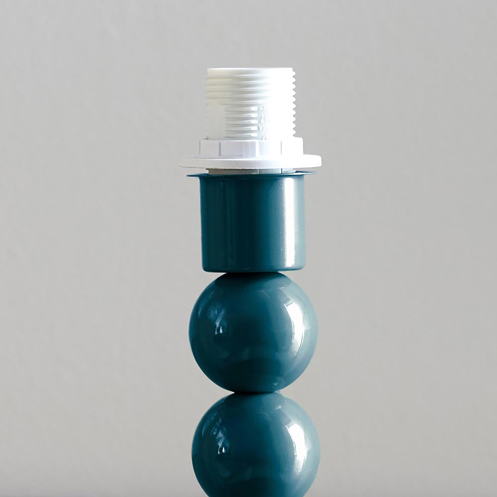 Brenleigh Table Lamp base in glossy blue, stacked metal spheres with white E14 bulb holder, shown against a plain light grey background.