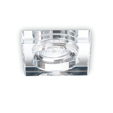 A close-up of the Eden Square Recessed Downlight - Clear, featuring a modern square design with a clear glass frame and a central GU10 bulb, installed against a white background. Its minimalist style enhances contemporary decor, while the dimmable lighting feature allows for versatile ambiance control.