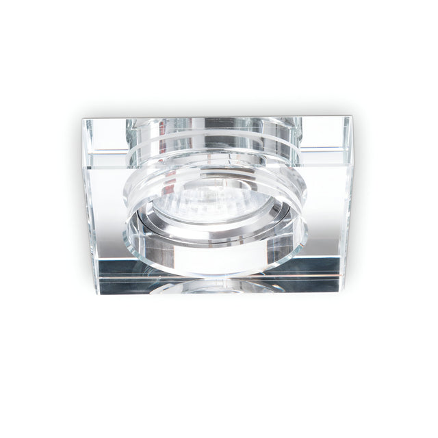 A close-up of the Eden Square Recessed Downlight - Clear, featuring a modern square design with a clear glass frame and a central GU10 bulb, installed against a white background. Its minimalist style enhances contemporary decor, while the dimmable lighting feature allows for versatile ambiance control.