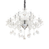 The Vivid Crystal 15 Light Chandelier - Chrome is a luxurious piece of decorative lighting featuring multiple arms with candle-style lights. It's adorned with tear-shaped crystals and strands, all hanging from a central frame. This chrome chandelier is elegantly designed for sophisticated settings.