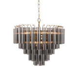 Endon Cranshaw 12 light tiered pendant with cylindrical smokey grey glass on a satin brass frame, hung from a chain against a white background.