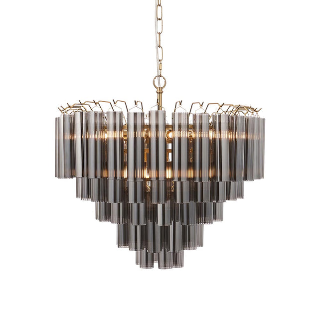 Endon Cranshaw 12 light tiered pendant with cylindrical smokey grey glass on a satin brass frame, hung from a chain against a white background.