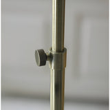 Close-up of the Endon Chartbourne floor lamp's antique brass stem with a knurled height-adjustment knob on the telescopic pole.