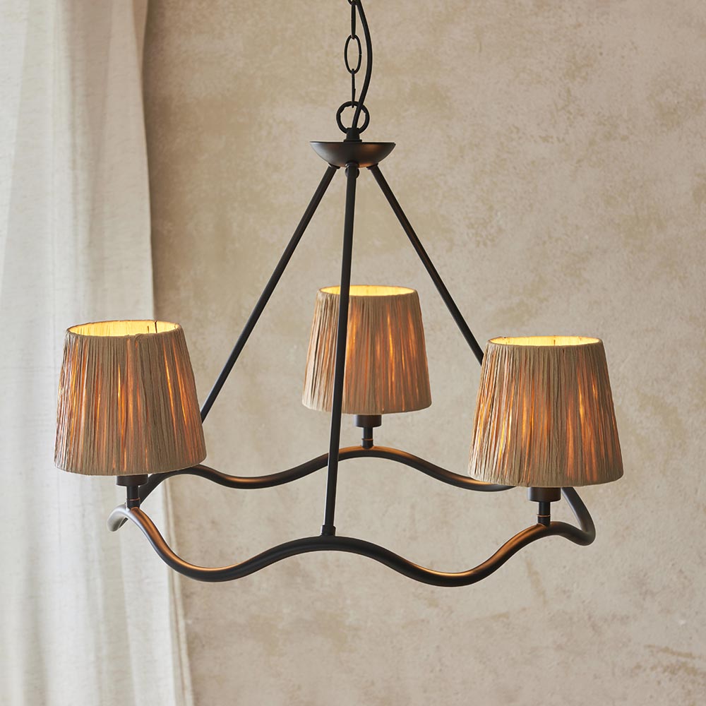 Endon Danemont 3 Light Pendant in black with a wave-shaped hoop holding three hand-wrapped raffia tapered shades, hanging from a chain against a neutral wall.