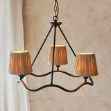 Endon Danemont 3 Light Pendant in black with a wave-shaped hoop holding three hand-wrapped raffia tapered shades, hanging from a chain against a neutral wall.