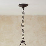 Close-up of the Endon Danemont 3 Light Pendant showing the matt black ceiling rose, chain suspension and top of the metal frame against a neutral wall.