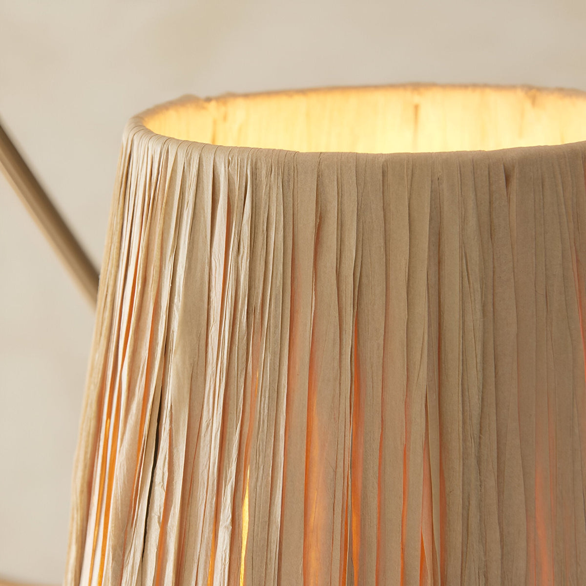 Close-up of the Danemont 3 Light Pendant in brass, showing a raffia-wrapped shade with textured natural strands and warm interior glow.